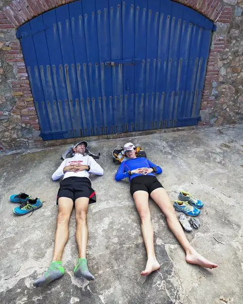Couple sleeping in front of a blue door